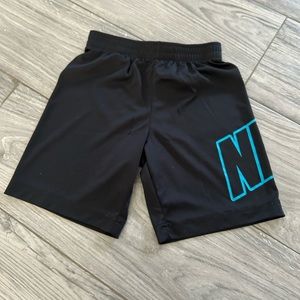 Nike Dry fit boys size 7 shorts, Black with neon blue lettering.